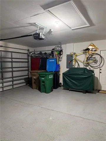 Garage with a garage door opener and electric panel