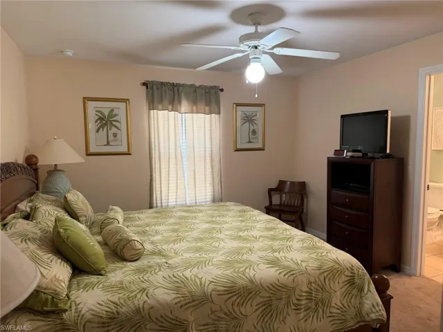 Bedroom featuring light carpet and a ceiling fan
