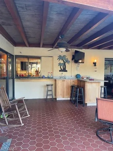View of patio / terrace with ceiling fan and an outdoor bar