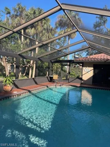 View of pool with a lanai