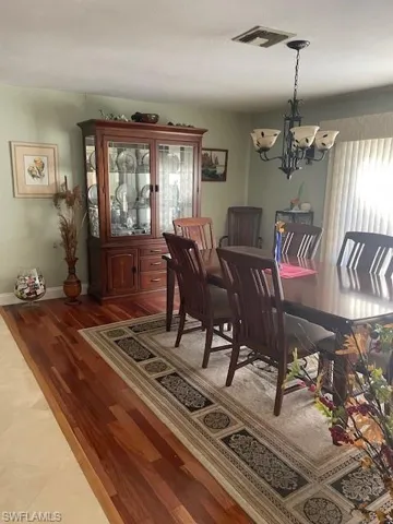 Dining area featuring light hardwood / wood-style flooring and a notable chandelier