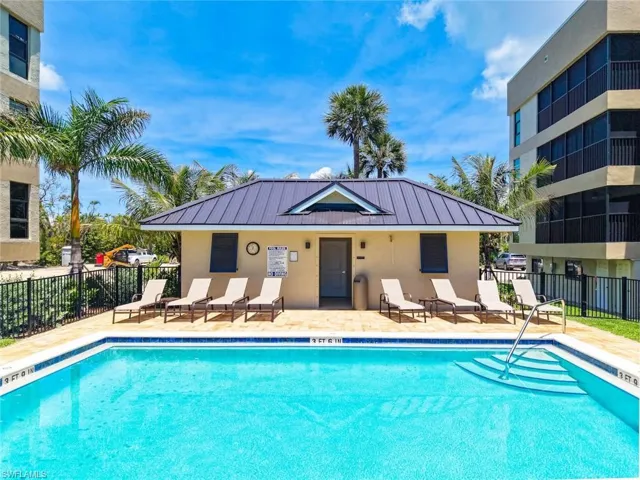 Outdoor swimming pool with built-in steps, surrounded by a paved deck