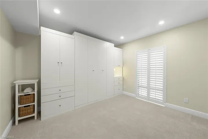 Built-in white cabinetry with various storage options