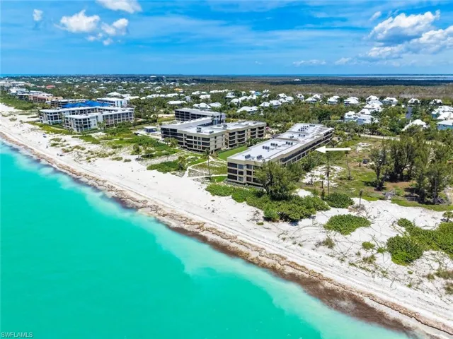 Coastal condominium building with direct beachfront access