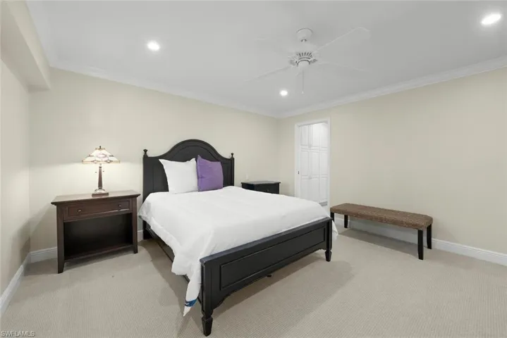 Neutral-toned carpet flooring with recessed lighting and crown molding