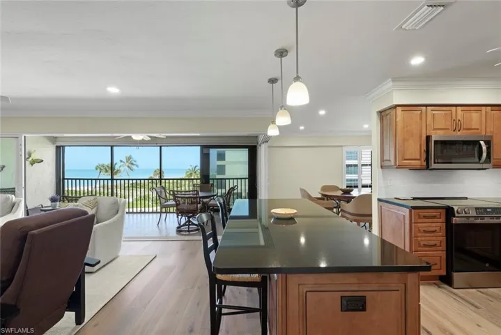 Open concept living space with wood-finish flooring