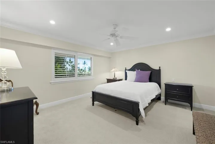 Bedroom featuring neutral wall tones, crown molding, and recessed lighting