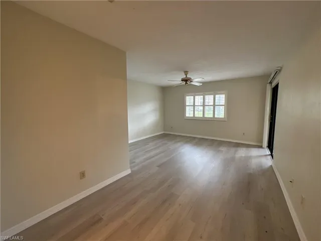 Spare room with ceiling fan and light wood-type flooring