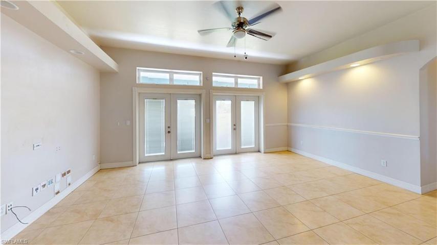 Living room with 2 french doors to back covered patio.