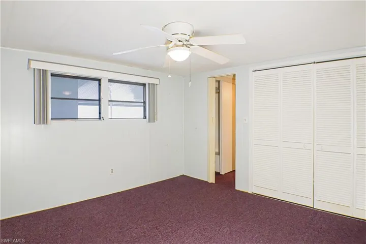 Unfurnished bedroom featuring carpet, a closet, and ceiling fan