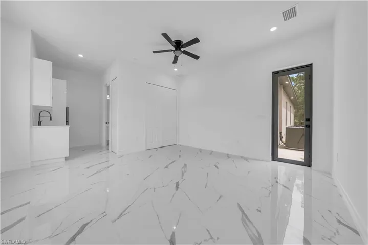 Spare room featuring light marble finish flooring, recessed lighting, and a ceiling fan