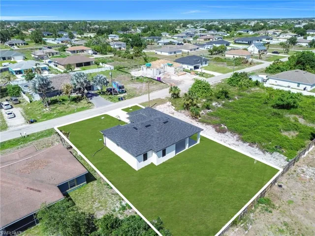 Newly constructed single-story residence featuring a dark shingle roof and white exterior