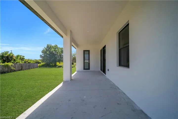 Covered patio featuring a concrete surface and substantial support columns
