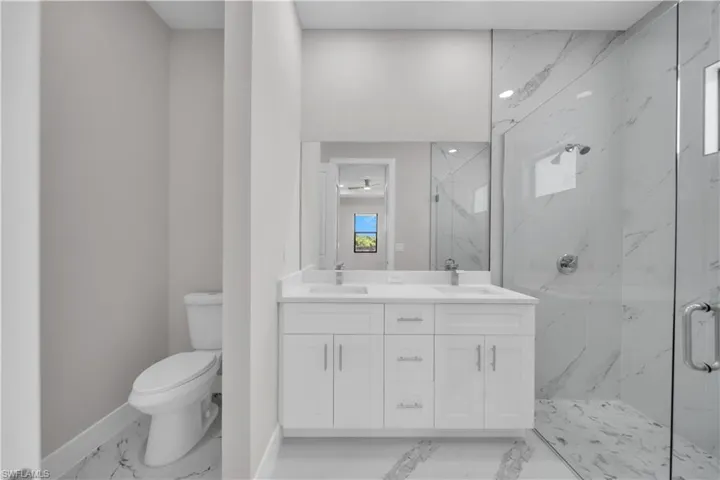 Contemporary bathroom featuring a dual vanity with white cabinetry and chrome hardware