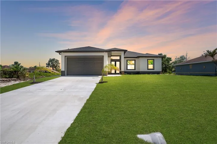 Contemporary single-story residence featuring a dark tile roof and a two-tone exterior
