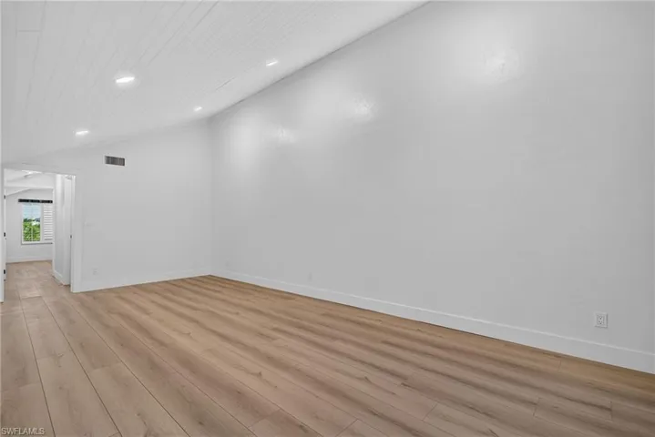 Loft Family Room with vaulted ceiling with tongue-and-groove paneling, recessed lighting, and wood-finish flooring