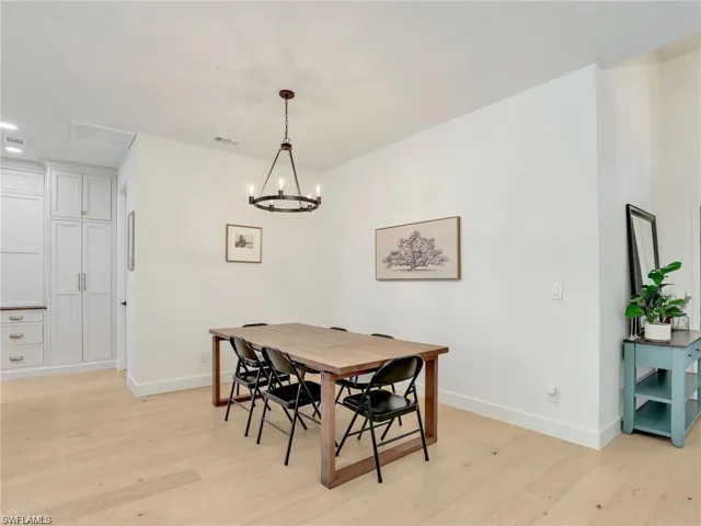Dining space with light wood-style flooring, a chandelier, and recessed lighting