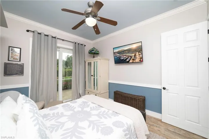 Bedroom with light wood-style flooring, access to exterior, baseboards, ceiling fan, and crown molding