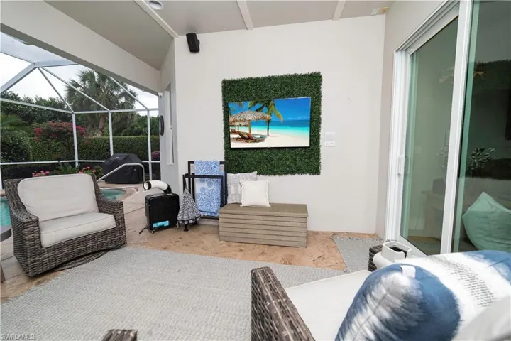 View of patio with glass enclosure and area for grilling