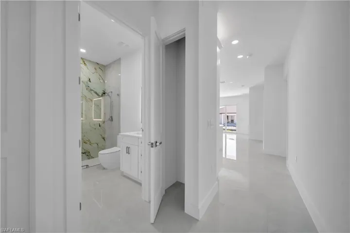 Hallway featuring recessed lighting and baseboards
