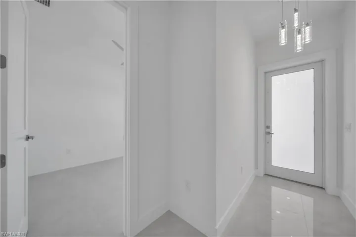 Entryway with baseboards and finished concrete floors