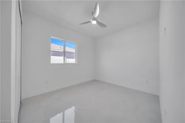 Spare room featuring baseboards and a ceiling fan