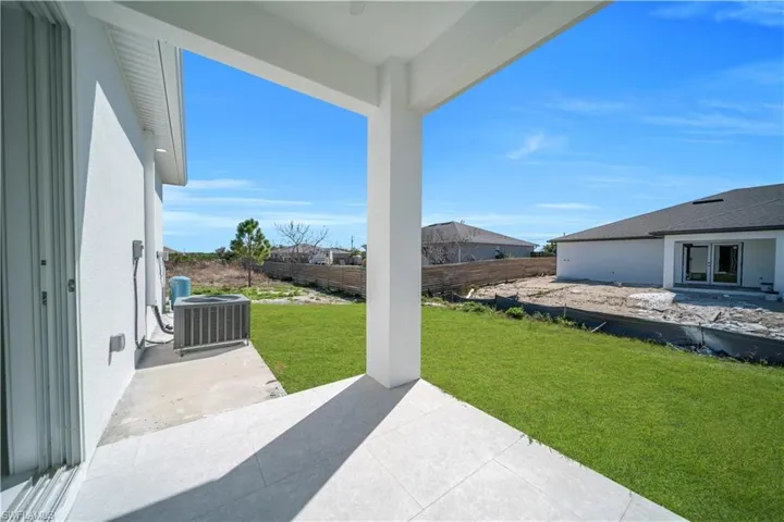 Fenced backyard featuring a patio area and french doors