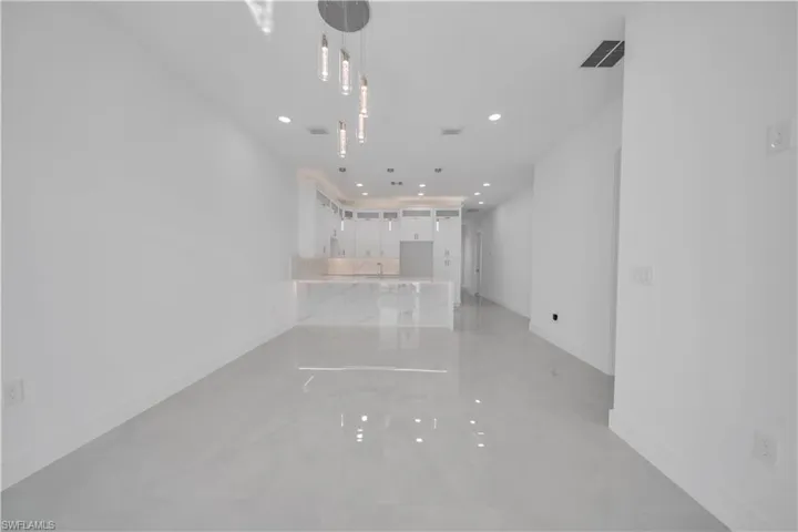 Unfurnished living room featuring recessed lighting and concrete flooring