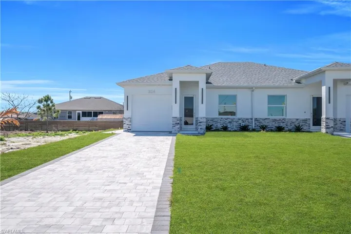 Prairie-style house with stone siding, stucco siding, decorative driveway, a garage, and a shingled roof
