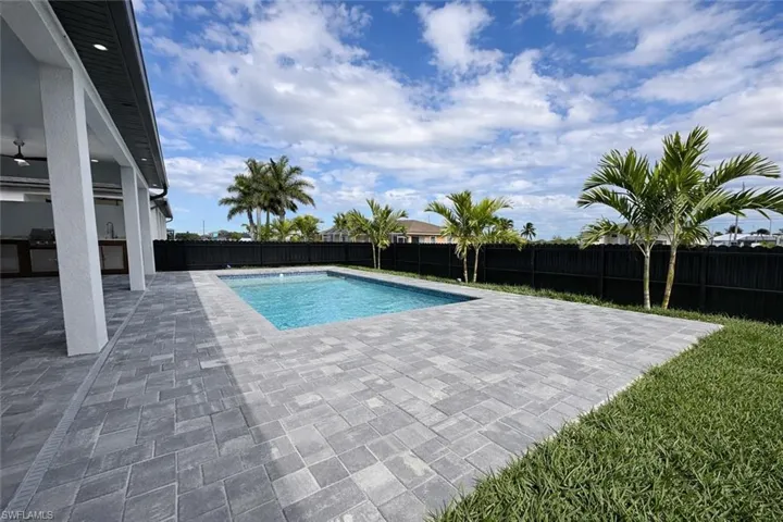 View of pool with a fenced backyard and patio surround