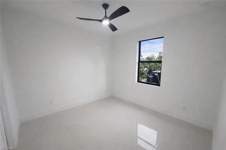 Spare room featuring ceiling fan and light tile patterned floors