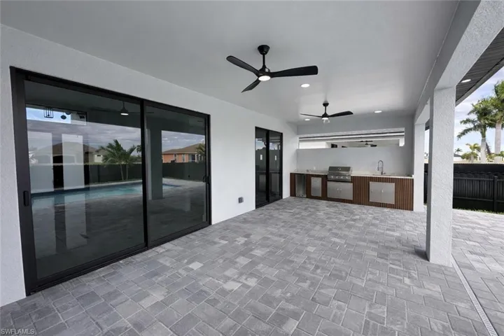 View of patio / terrace featuring an outdoor kitchen and a ceiling fan