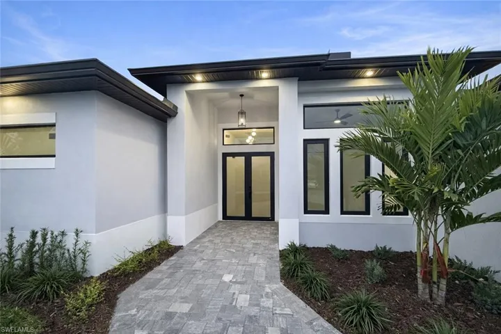 Property entrance featuring stucco siding