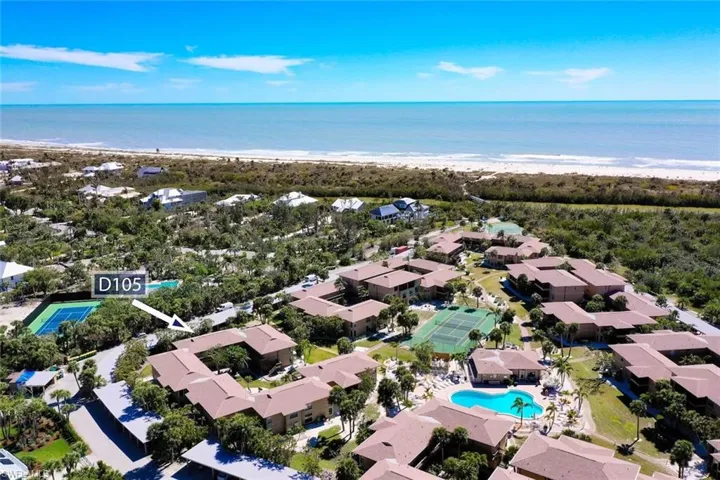 Aerial view featuring a beach view and a water view