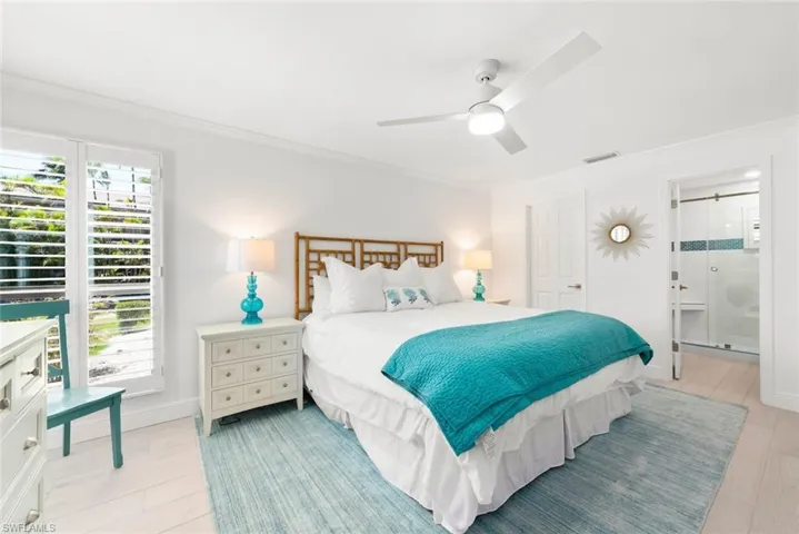 Bedroom featuring ceiling fan, ornamental molding, light wood finished floors, and visible vents
