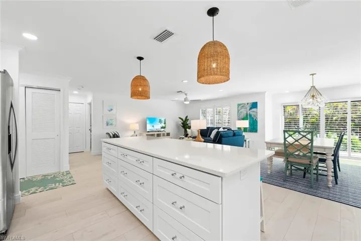 Kitchen featuring visible vents, stainless steel fridge, light wood-type flooring, and open floor plan
