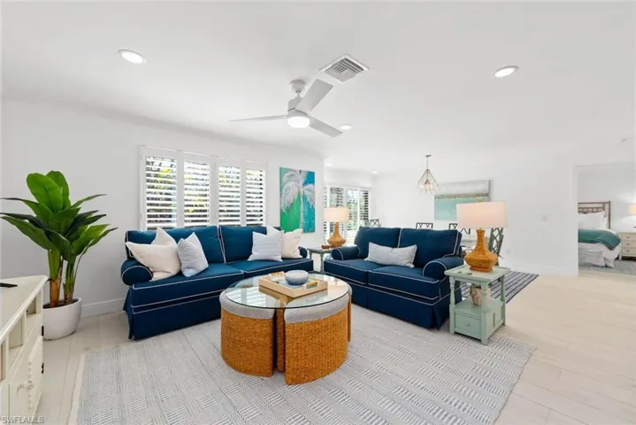 Living room with visible vents, recessed lighting, a ceiling fan, and wood finished floors