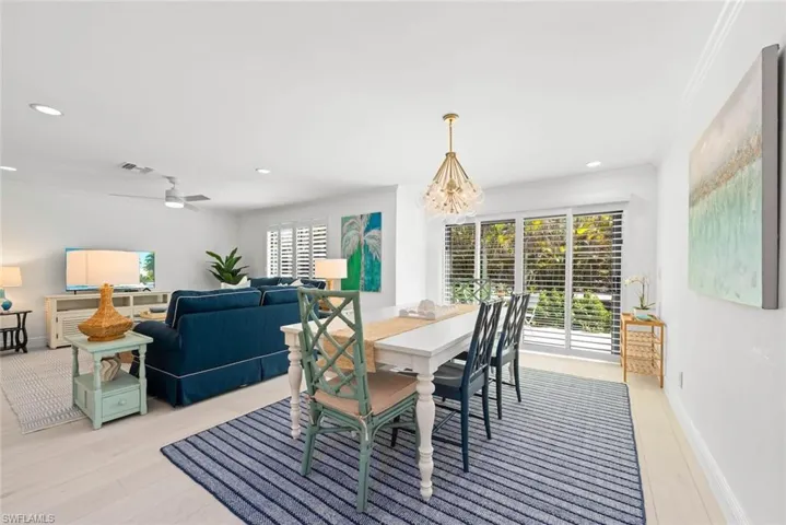 Dining area with plenty of natural light, baseboards, visible vents, and a chandelier