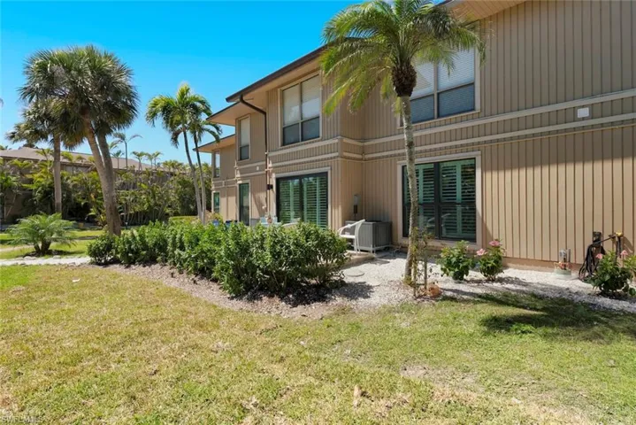 Back of house with a lawn