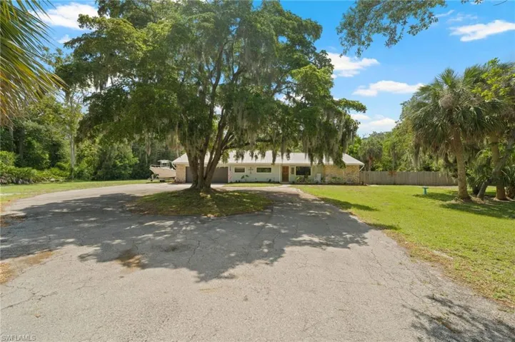 View of front facade with asphalt driveway