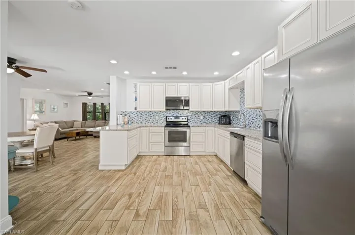 Kitchen is open to dining area and great room.  Door out to Lanai, Laudry room off to the side