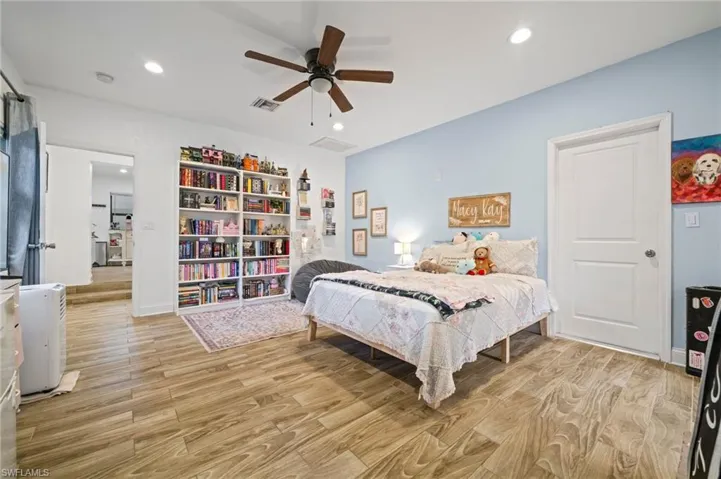 Bedroom with light wood-type flooring, recessed lighting, and ceiling fan