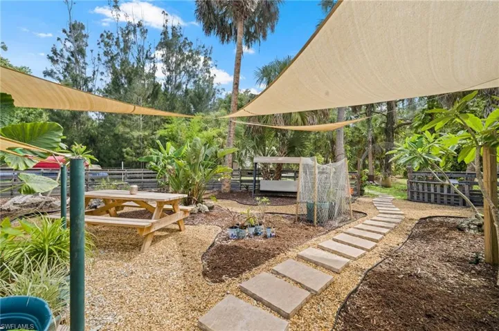 Sun shade sails make for lovely garden area with steps to back yard.
