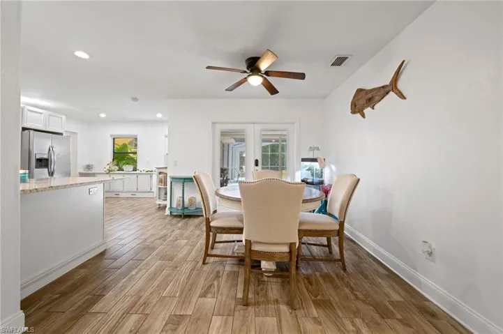 Dining space featuring light wood-style floors, a ceiling fan, and recessed lighting