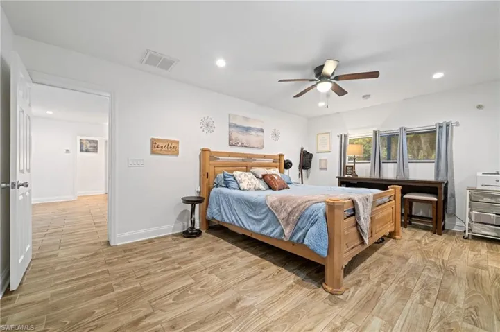 Bedroom featuring light wood finished floors, recessed lighting, and a ceiling fan