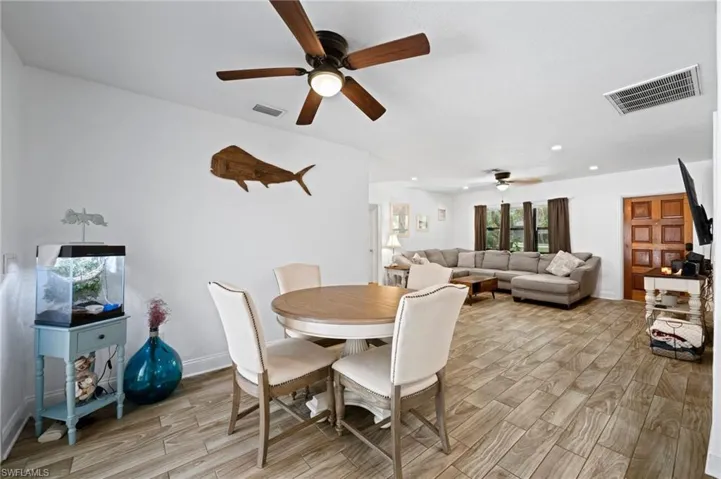 Dining room featuring ceiling fan, light wood-type flooring, and recessed lighting
