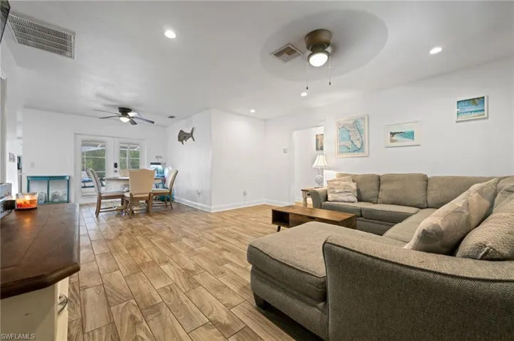 Living area featuring a ceiling fan, recessed lighting, and light wood-style tile floors