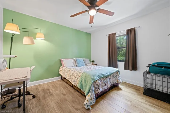 Bedroom #2 featuring wood finished floors and ceiling fan