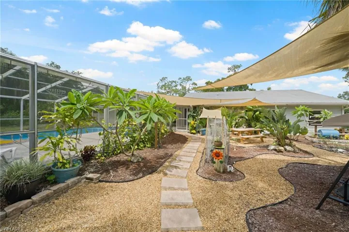 View of yard with an outdoor pool, a patio, and a lanai