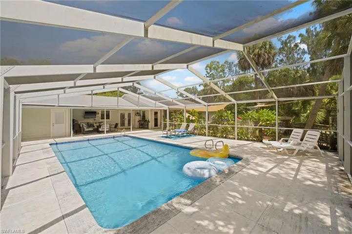 Swimming pool with a patio and a lanai